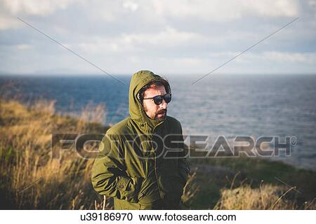 "Mid adult man strolling along windy coast, Sorso, Sassari, Sardinia, Italy" View Large Photo Image Stock Image - "Mid adult man strolling along windy coast, Sorso, Sassari, Sardinia, Italy". Fotosearch