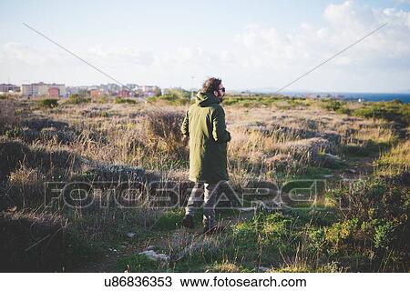 "Mid adult man strolling toward coast, Sorso, Sassari, Sardinia, Italy" View Large Photo Image Stock Image - "Mid adult man strolling toward coast, Sorso, Sassari, Sardinia, Italy". Fotosearch