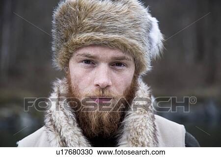 "Mid adult man wearing trapper hat, portrait" View Large Photo Image Stock Image - "Mid adult man wearing trapper hat, portrait". Fotosearch