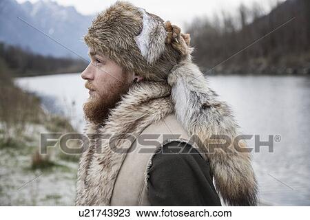 "Mid adult man wearing trapper hat, portrait" View Large Photo Image Stock Image - "Mid adult man wearing trapper hat, portrait". Fotosearch