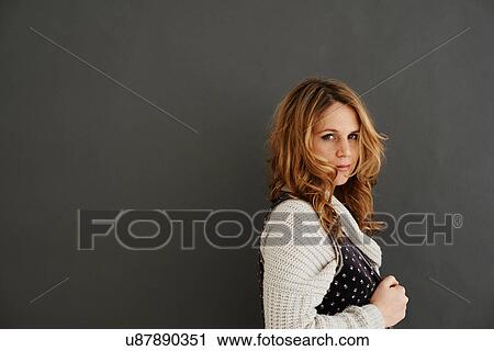 Mid adult woman side view looking at camera View Large Photo Image Stock Image - Mid adult woman side view looking at camera. Fotosearch