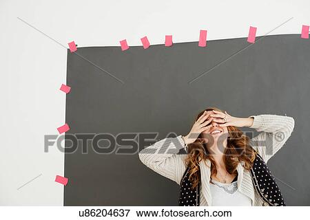 "Mid adult woman smiling, hands covering eyes" View Large Photo Image Stock Photo - "Mid adult woman smiling, hands covering eyes". Fotosearch