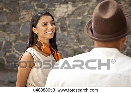 "Mid adult woman standing with man, smiling" View Large Photo Image Stock Image - "Mid adult woman standing with man, smiling". Fotosearch