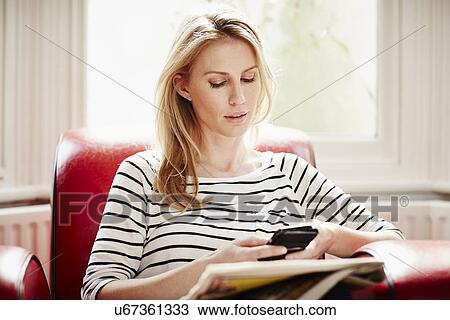 Mid adult woman using smartphone View Large Photo Image Stock Image - Mid adult woman using smartphone. Fotosearch