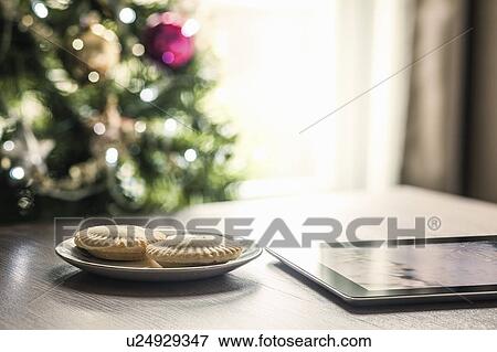 Mince pies and digital tablet on table View Large Photo Image Stock Photo - Mince pies and digital tablet on table. Fotosearch