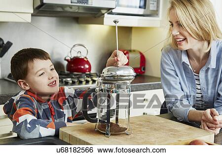 Mother and son making coffee in cafetiere View Large Photo Image Stock Photograph - Mother and son making coffee in cafetiere. Fotosearch