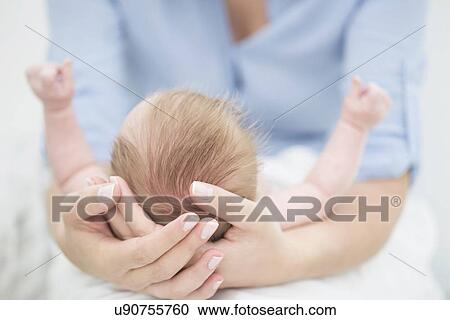 Mother cradling baby in arms View Large Photo Image Stock Image - Mother cradling baby in arms. Fotosearch