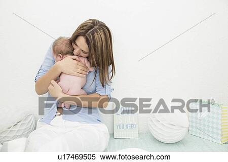 Mother cradling baby in arms View Large Photo Image Stock Photography - Mother cradling baby in arms. Fotosearch
