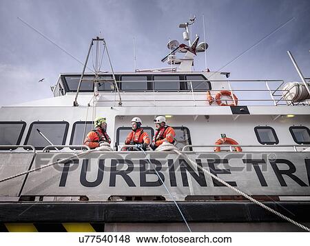 Offshore windfarm engineers in port on ship View Large Photo Image Stock Photo - Offshore windfarm engineers in port on ship. Fotosearch