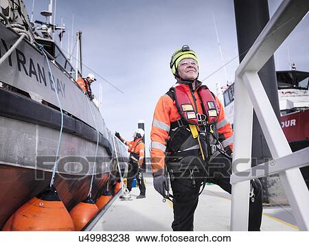 Offshore windfarm engineers in port with boats View Large Photo Image Stock Photo - Offshore windfarm engineers in port with boats. Fotosearch