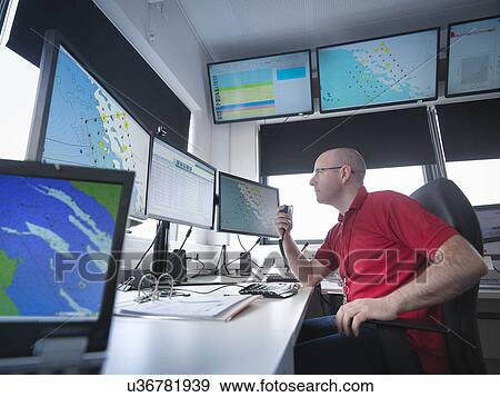 Stock Photo - Operator in offshore windfarm control room. Fotosearch