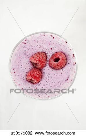 Stock Image - Overhead still life of fresh raspberry smoothie. Fotosearch