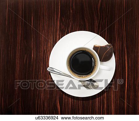 Picture - Overhead view of a black coffee on wooden table. Fotosearch