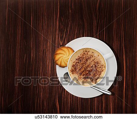 Overhead view of a cappuccino coffee on wooden table View Large Photo Image Stock Image - Overhead view of a cappuccino coffee on wooden table. Fotosearch