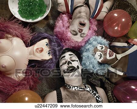 Overhead view of three adults wearing clown face paint and wigs with blow up doll View Large Photo Image Stock Photo - Overhead view of three adults wearing clown face paint and wigs with blow up doll. Fotosearch