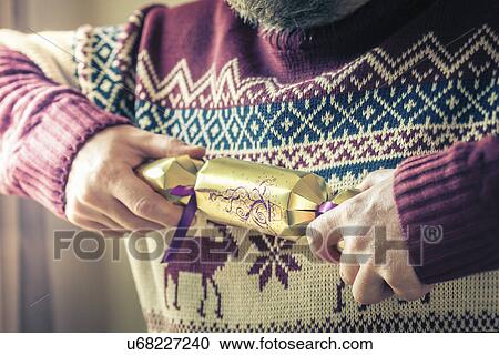 Person pulling christmas cracker alone View Large Photo Image Stock Image - Person pulling christmas cracker alone. Fotosearch