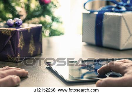 Stock Photo - "Person using digital tablet, close up". Fotosearch