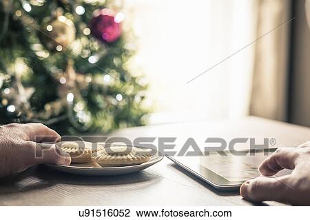 Person using digital tablet with mince pies View Large Photo Image Stock Image - Person using digital tablet with mince pies. Fotosearch
