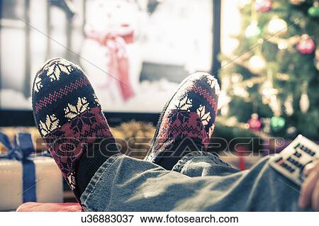 Person wearing slippers with feet up View Large Photo Image Stock Photo - Person wearing slippers with feet up. Fotosearch