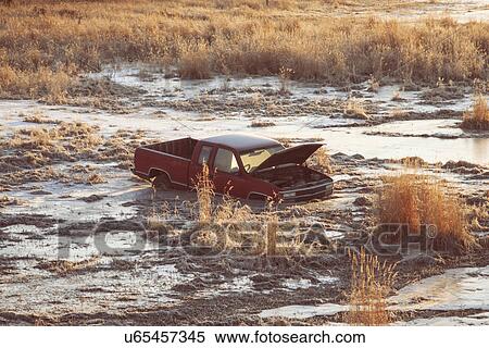Stock Photography - Pick up truck stuck in swamp. Fotosearch