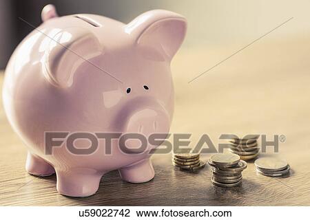 Stock Image - Piggy bank and coins. Fotosearch