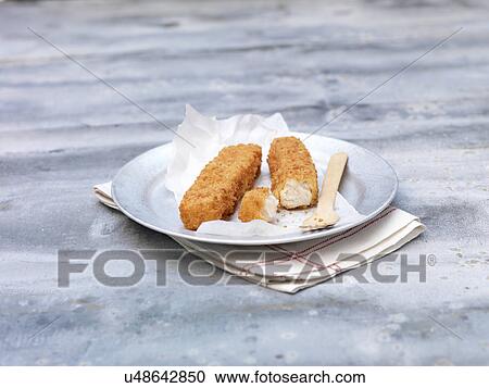 Plate of fried chunky breaded fish fingers on steel table View Large Photo Image Stock Image - Plate of fried chunky breaded fish fingers on steel table. Fotosearch