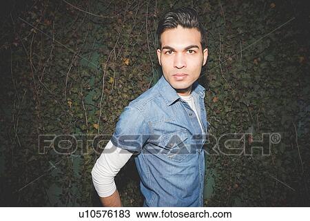 Portrait of a young man looking at camera View Large Photo Image Stock Image - Portrait of a young man looking at camera. Fotosearch
