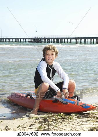"Portrait of boy nipper (child surf life savers) sitting on surfboard, Altona, Melbourne, Australia" View Large Photo Image Stock Image - "Portrait of boy nipper (child surf life savers) sitting on surfboard, Altona, Melbourne, Australia". Fotosearch
