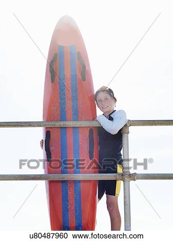 "Portrait of boy nipper (child surf life savers) leaning against railings, Altona, Melbourne, Australia" View Large Photo Image Stock Image - "Portrait of boy nipper (child surf life savers) leaning against railings, Altona, Melbourne, Australia". Fotosearch