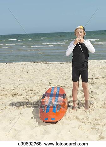 "Portrait of boy nipper (child surf life savers) fastening cap, Altona, Melbourne, Australia" View Large Photo Image Stock Photo - "Portrait of boy nipper (child surf life savers) fastening cap, Altona, Melbourne, Australia". Fotosearch
