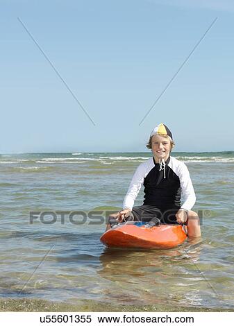 "Portrait of boy nipper (child surf life savers) astride surfboard, Altona, Melbourne, Australia" View Large Photo Image Stock Photography - "Portrait of boy nipper (child surf life savers) astride surfboard, Altona, Melbourne, Australia". Fotosearch