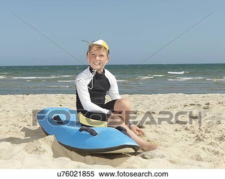 Stock Photography - "Portrait of boy nipper (child surf life savers) on surfboard at beach, Altona, Melbourne, Australia". Fotosearch