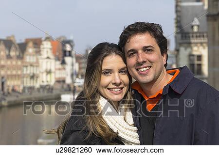 Stock Image - "Portrait of couple by Leie river, Ghent, Flanders, Belgium". Fotosearch