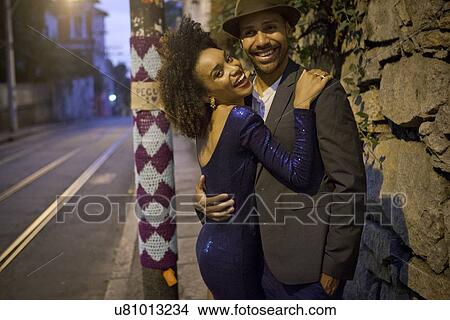 Portrait of couple hugging in street at night View Large Photo Image Picture - Portrait of couple hugging in street at night. Fotosearch