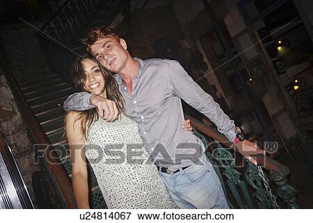 Stock Photo - "Portrait of couple standing in bar, smiling". Fotosearch