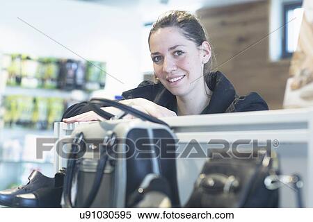 Portrait of female sales assistant in shoe shop View Large Photo Image Stock Photography - Portrait of female sales assistant in shoe shop. Fotosearch