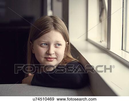 Portrait of girl gazing through window from kitchen breakfast bar View Large Photo Image Stock Photo - Portrait of girl gazing through window from kitchen breakfast bar. Fotosearch
