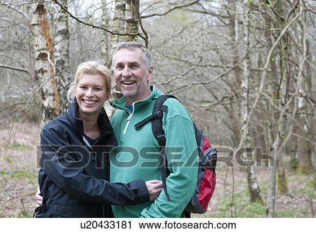 Portrait of hiking couple walking in woods View Large Photo Image Stock Image - Portrait of hiking couple walking in woods. Fotosearch