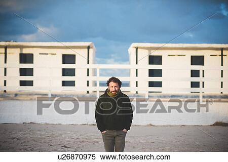 "Portrait of mid adult man in front of beach huts, Sorso, Sassari, Sardinia, Italy" View Large Photo Image Stock Photography - "Portrait of mid adult man in front of beach huts, Sorso, Sassari, Sardinia, Italy". Fotosearch