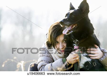 Portrait of mid adult woman hugging her dog View Large Photo Image Stock Image - Portrait of mid adult woman hugging her dog. Fotosearch