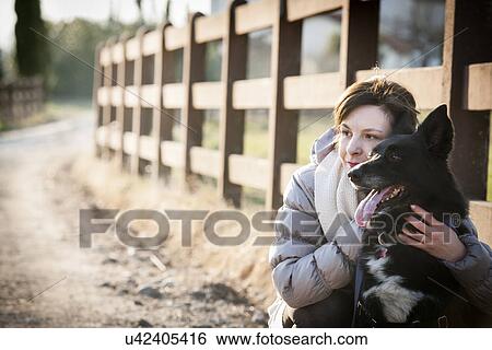 Portrait of mid adult woman with her dog on country lane View Large Photo Image Stock Photograph - Portrait of mid adult woman with her dog on country lane. Fotosearch