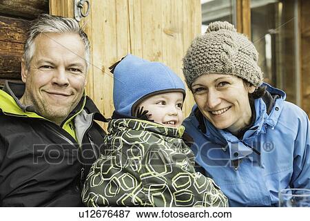 Stock Photo - "Portrait of mother, father and son, wearing skiwear, smiling". Fotosearch