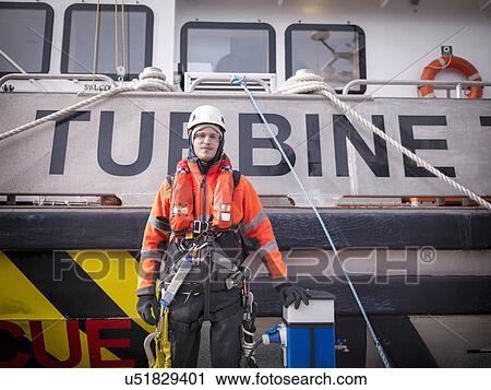 Stock Image - Portrait of offshore windfarm engineer in port. Fotosearch