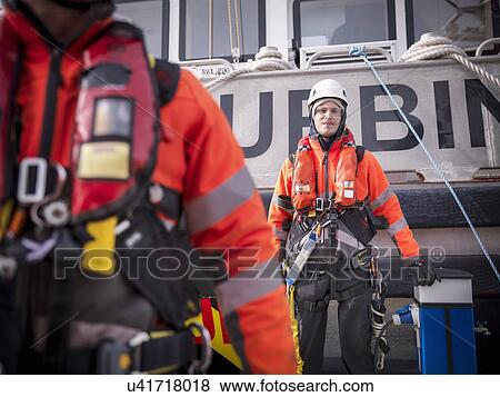 Stock Photo - Portrait of offshore windfarm engineer apprentice in port. Fotosearch