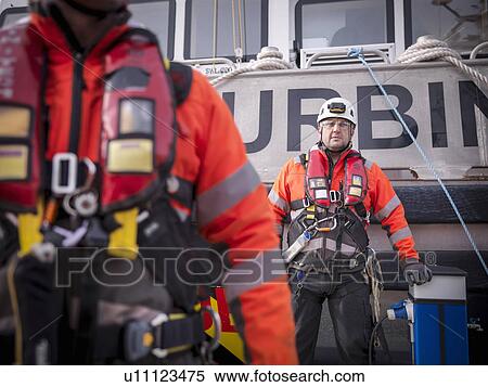 Stock Photography - Portrait of offshore windfarm engineer apprentice in port. Fotosearch