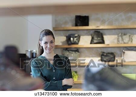 Portrait of proud female sales assistant in shoe shop View Large Photo Image Stock Image - Portrait of proud female sales assistant in shoe shop. Fotosearch
