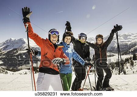 "Portrait of skiers on slope, arms raised, smiling" View Large Photo Image Stock Image - "Portrait of skiers on slope, arms raised, smiling". Fotosearch