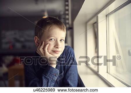 Portrait of smiling boy with chin on hand View Large Photo Image Stock Photo - Portrait of smiling boy with chin on hand. Fotosearch