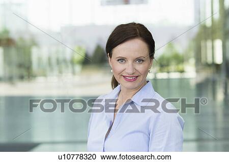 Stock Image - Portrait of smiling mature woman. Fotosearch