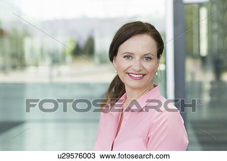 Stock Image - Portrait of smiling mature woman. Fotosearch